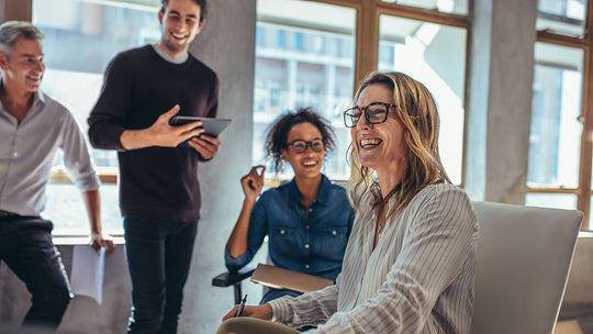 Happy female Team Leader leading a meeting with her team